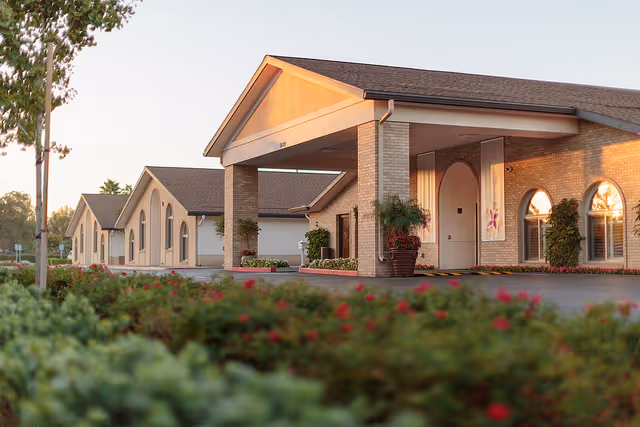 Exterior view of Arlington Gardens Care Center with entrance portico and landscaping.