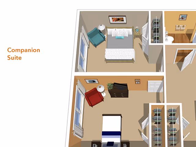 3D floor plan of a companion suite showing two bedrooms, each with a bed, armchair, nightstand with lamp, and dresser. The rooms have windows with curtains and some wall decorations. The layout also includes closets and a bathroom area.