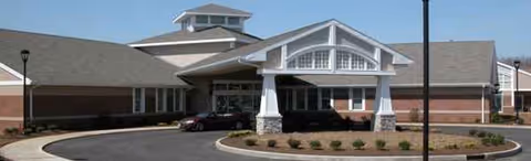 Aultman Transitional Care Center front entrance with curved driveway and landscaped planters.