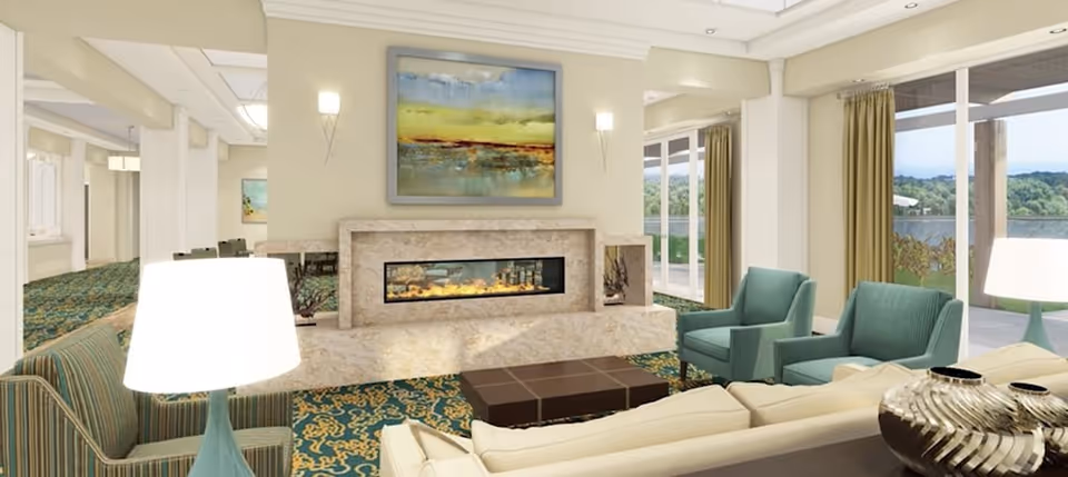 Bright, open lounge with modern fireplace, sofas and armchairs facing large windows overlooking greenery.