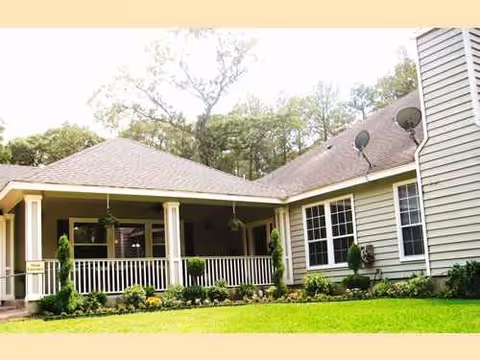 Front exterior of a single-story senior living residence with a covered porch.