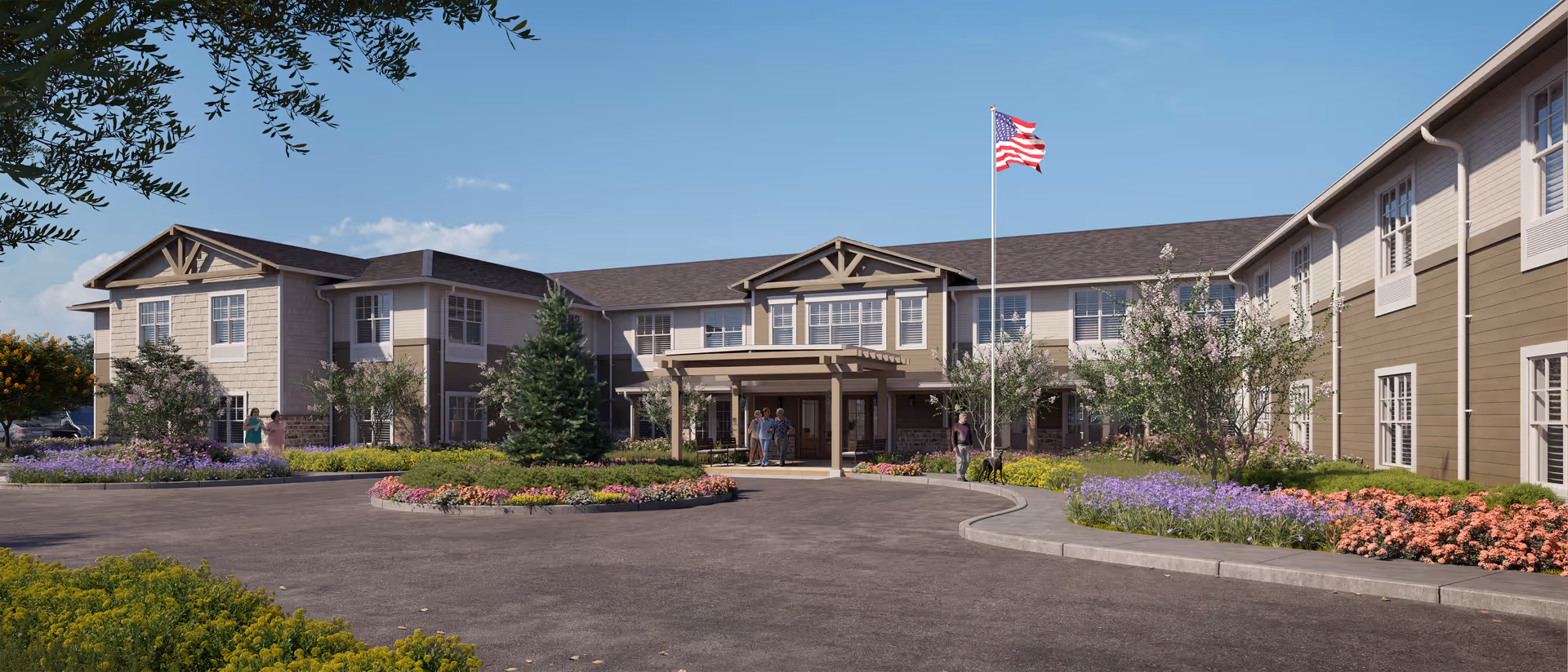 Front exterior of a two-story senior living building with a landscaped circular driveway, American flagpole, and people near the entrance.