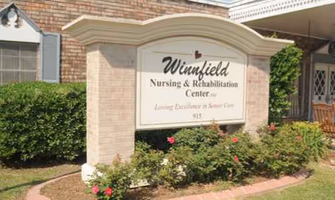 The Winnfield Nursing and Rehabilitation Center sign at a brick entrance with greenery.