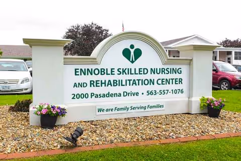 Exterior sign for Ennoble Skilled Nursing and Rehabilitation Center with landscaping.