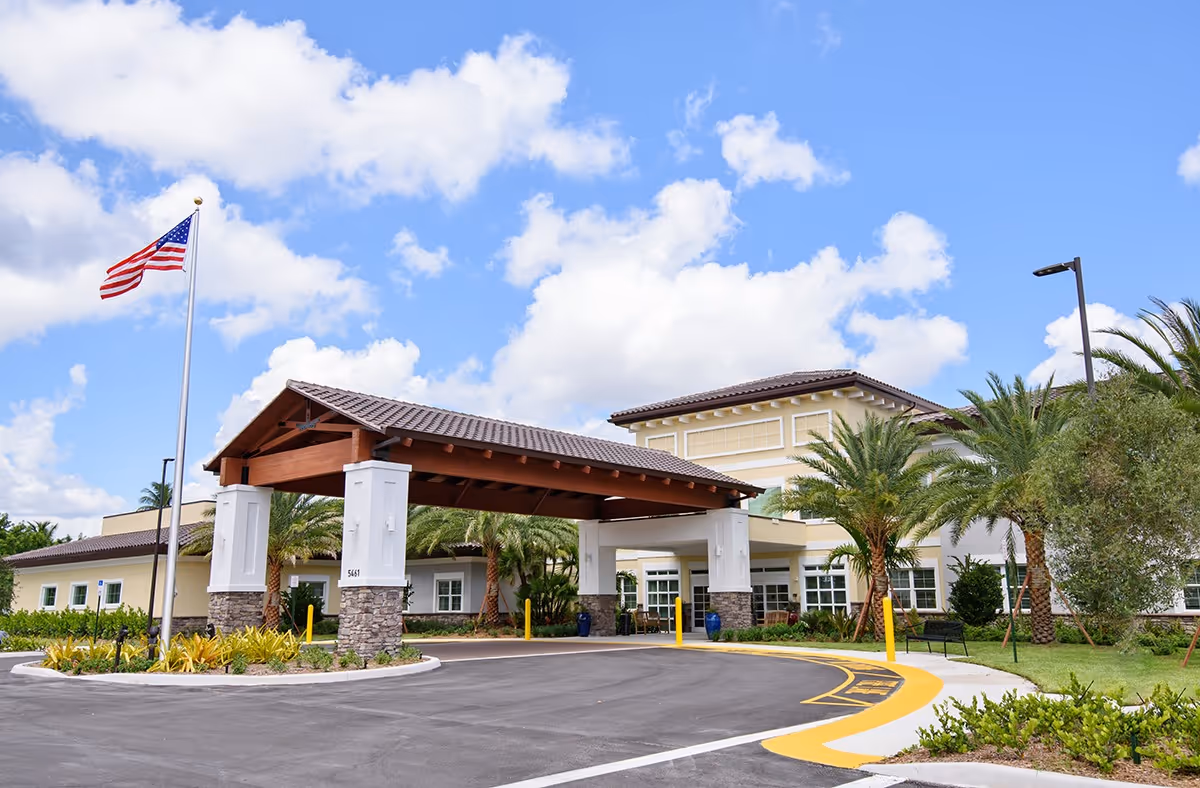 Sunny exterior of YOURLife of Coconut Creek with porte-cochere entrance and palm trees