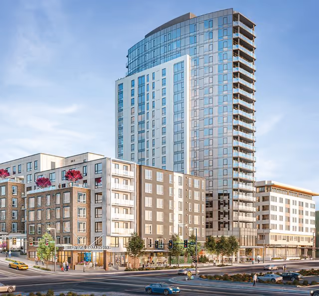 Modern multi-story residential building complex with a tall glass tower and several mid-rise buildings featuring balconies and rooftop greenery, situated at a busy urban intersection with cars and pedestrians.