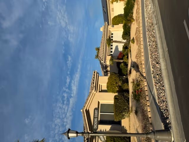 Exterior view of Ampm Comfort Care entrance with landscaped pathway.