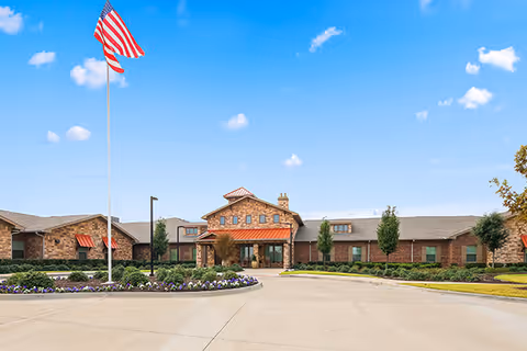 Front exterior view of Rock Ridge Assisted Living and Memory Care with flagpole.