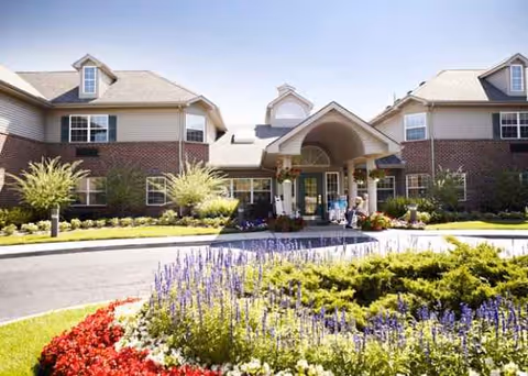 Front view of Comfort Cove Premier Senior Living building with manicured landscaping and welcoming entrance.