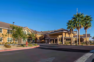 Exterior view of Marquis Care at Centennial Hills with palm trees and entrance