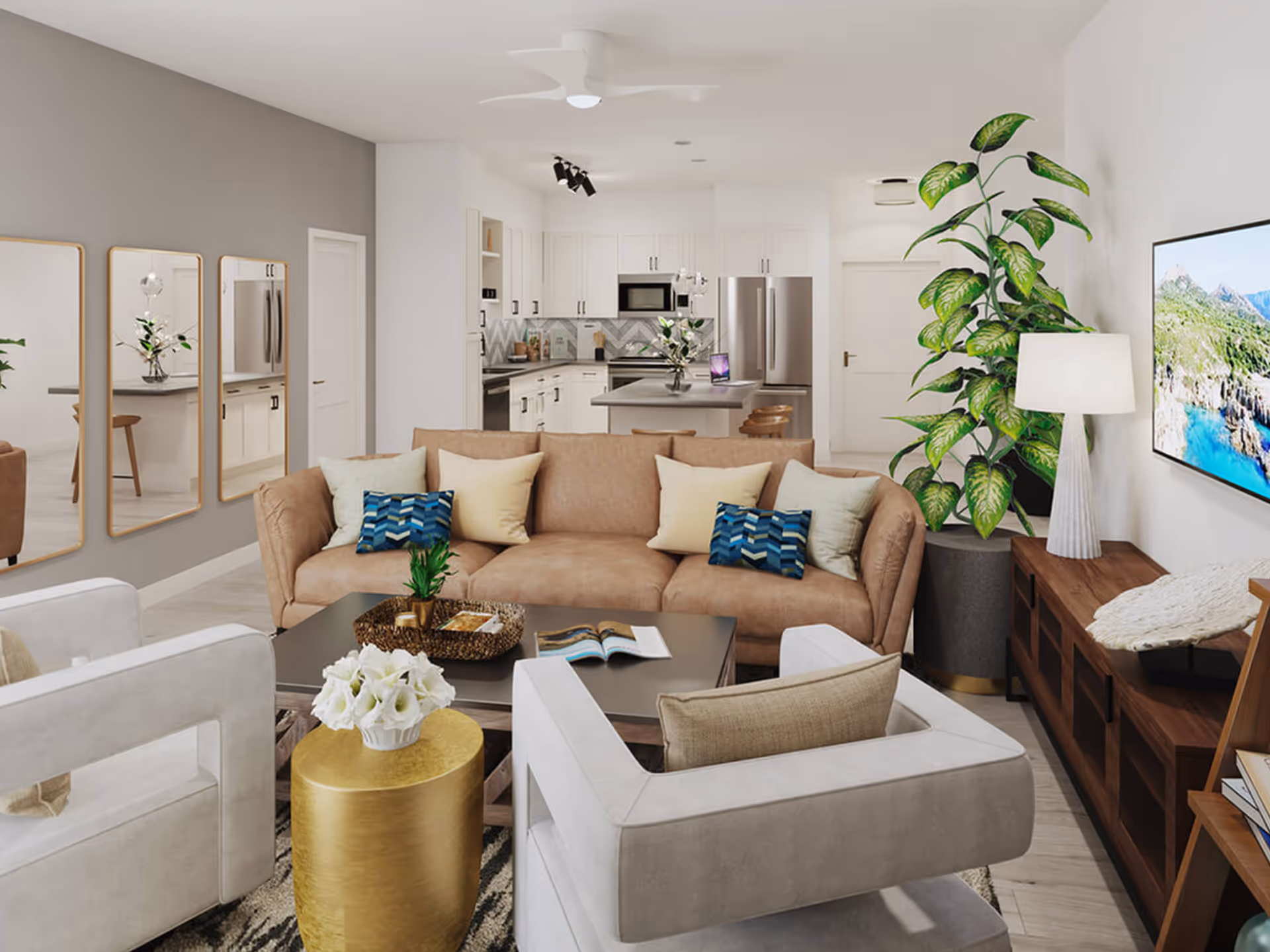 Open-concept living room with a tan sofa, armchairs, coffee table and TV, opening into a white kitchen.