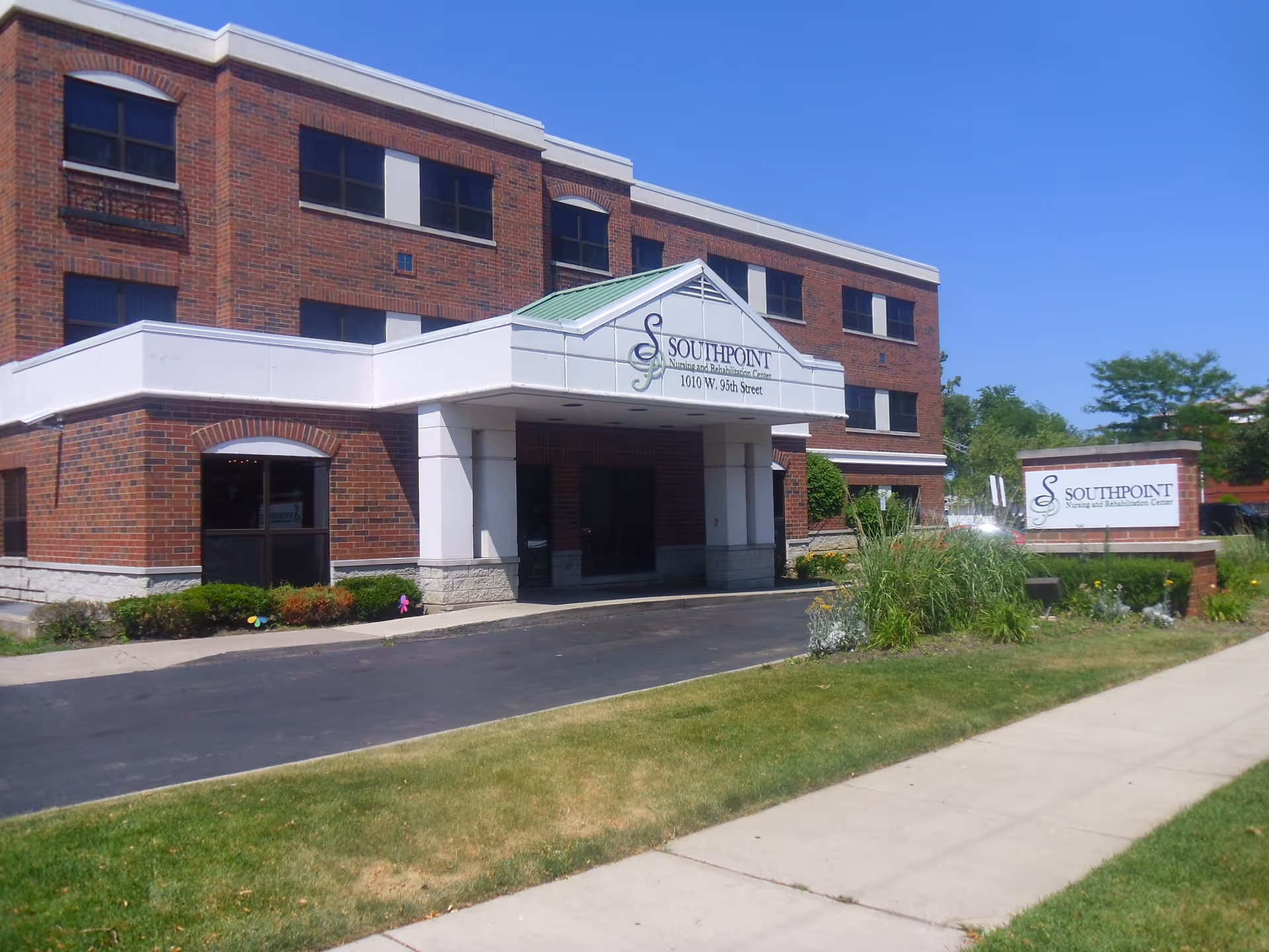 Front exterior of the Southpoint Nursing and Rehabilitation Center building with an entrance canopy and a lawn sign.