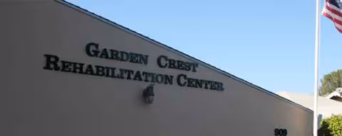 Front exterior of Garden Crest Rehabilitation Center with an American flag.