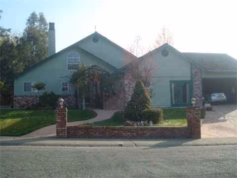 Exterior of Clementine Home Care, a single-story building with a brick front fence and landscaped yard.