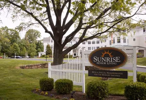Sunrise Senior Living facility exterior with a large sign and manicured landscaping.