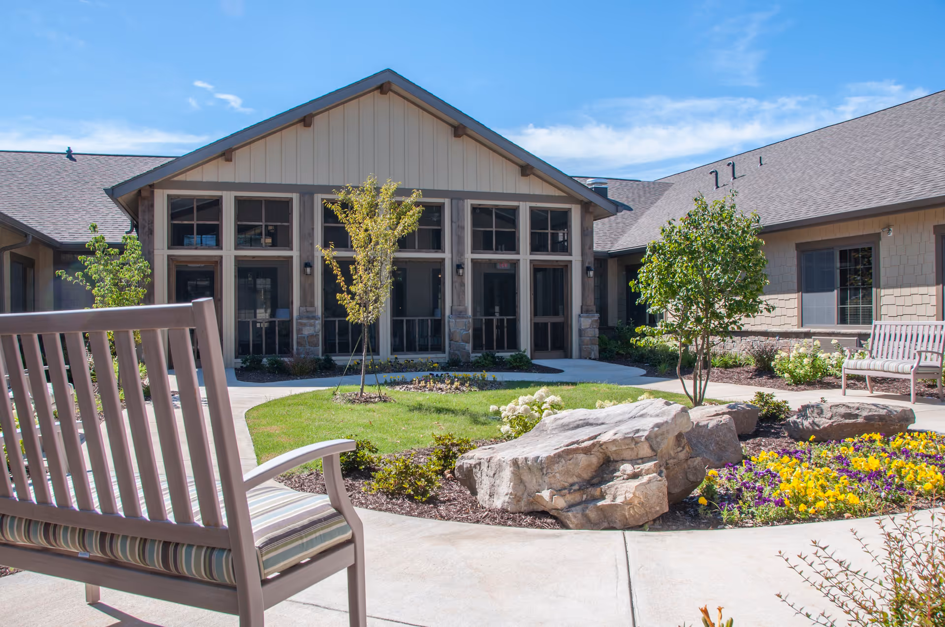 Exterior view of Thrive at Brow Wood with benches, landscaping, and a welcoming entrance.