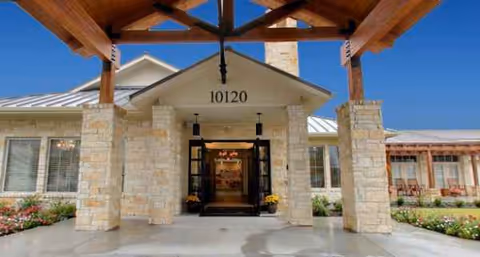 The Auberge at Vintage Lake exterior entrance features stone columns and the address 10120.