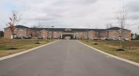 Driveway leads to The Pavilion Senior Living Smyrna, a brick building with a central entrance.