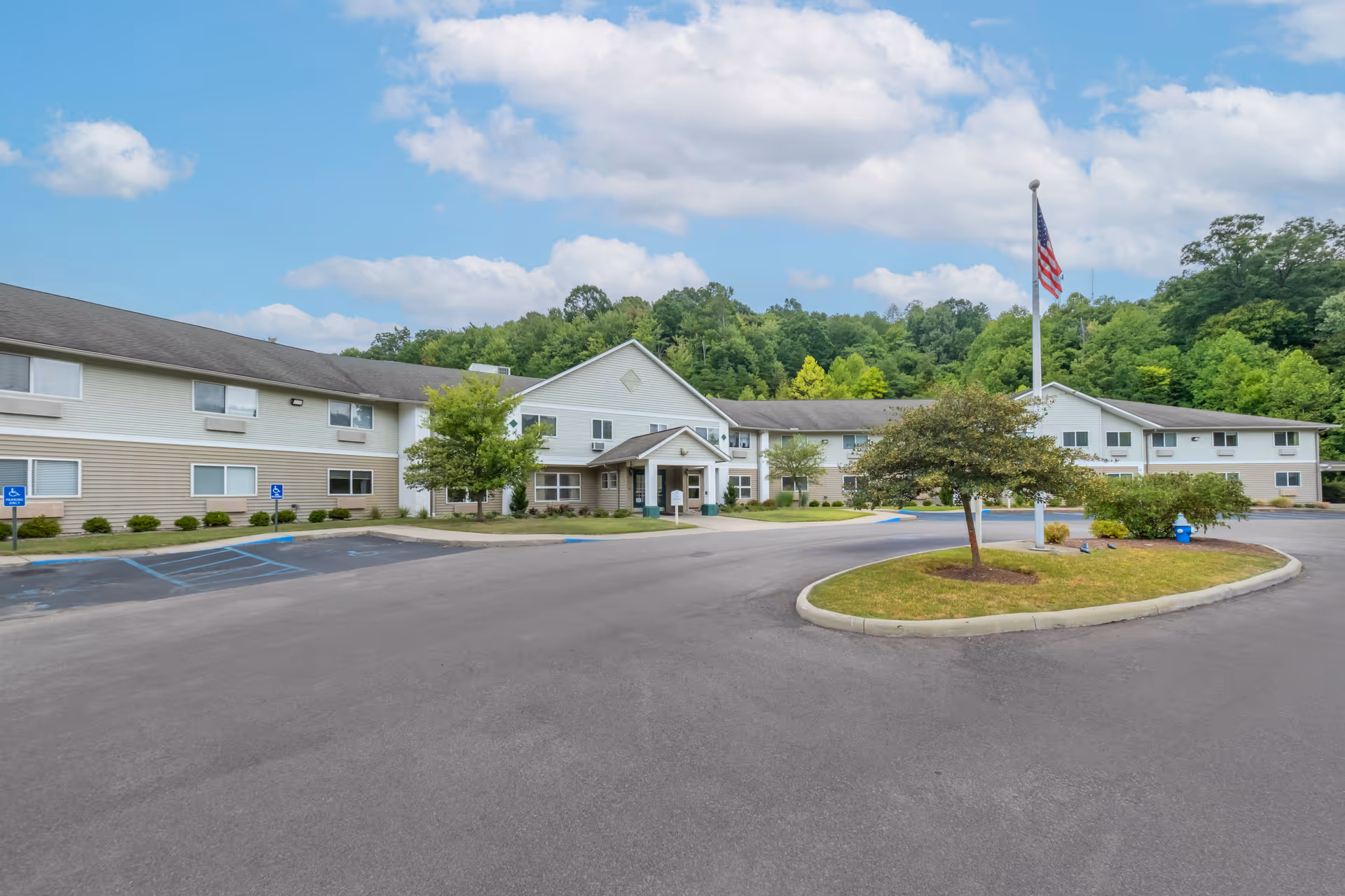 Exterior view of Brookdale Charleston Gardens with circular driveway and entrance lobby.