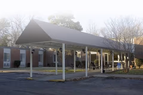 Exterior view of Whitehaven Community Living Center with a covered entrance and parking.