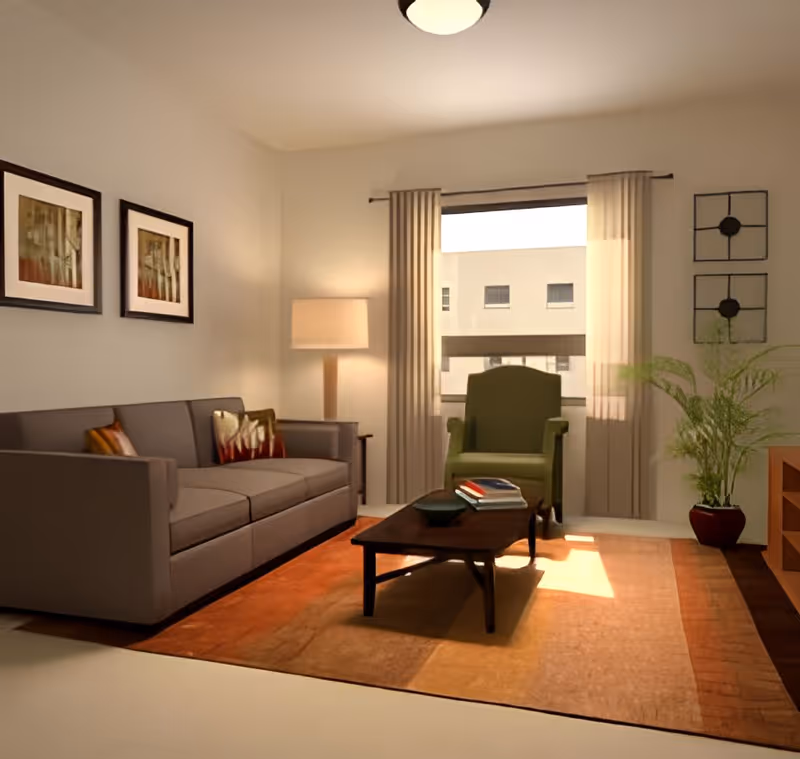 Sunlit living room with a gray sofa, green armchair, coffee table on an orange rug, floor lamp and framed art.