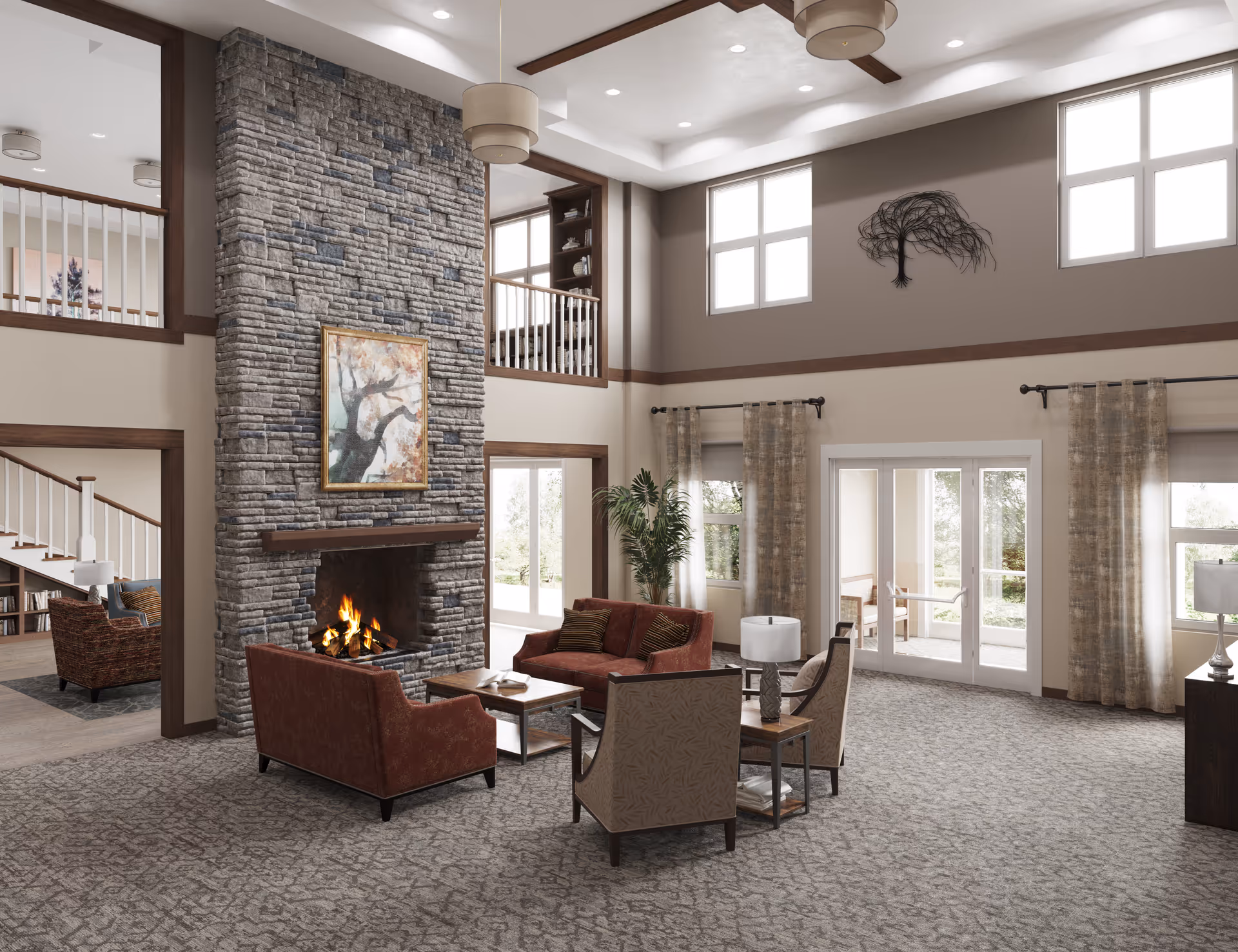 Bright two-story communal living room with a stone fireplace, seating area, tall windows and double doors to the outdoors.