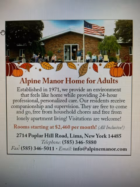 Front view of Alpine Manor Home for Adults building with an American flag on a flagpole in front, surrounded by trees and greenery.