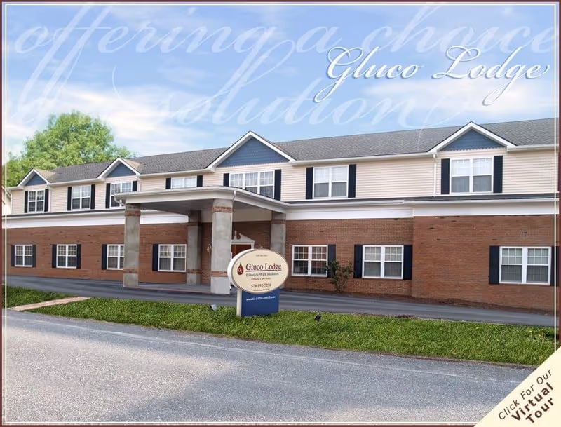 Front exterior of a two-story brick-and-siding senior care building with a covered entrance and a sign reading "Gluco Lodge".