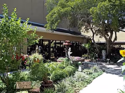 Exterior view of Community Health and Rehabilitation Center with a landscaped garden and fountain.