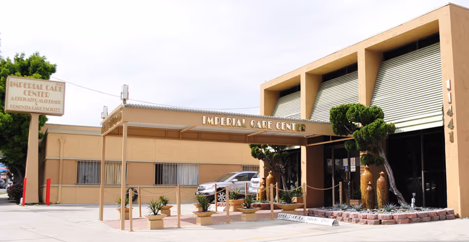 Exterior view of Imperial Care Center with entrance, sign, and decorative landscaping.