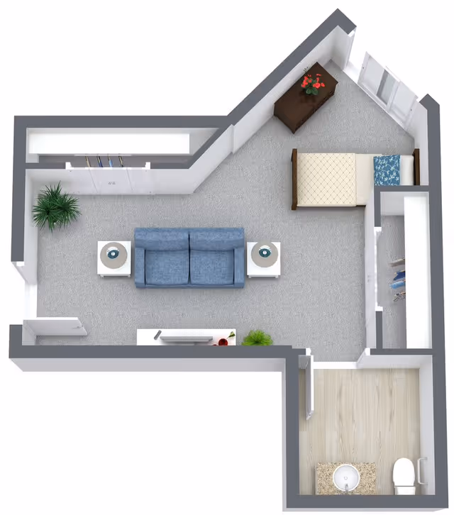 3D floor plan of a senior living unit at Gables of Ojai featuring a combined living and bedroom area with a blue sofa, two side tables with lamps, a bed, a dresser with flowers, and a closet. There is a separate bathroom with a toilet and sink.
