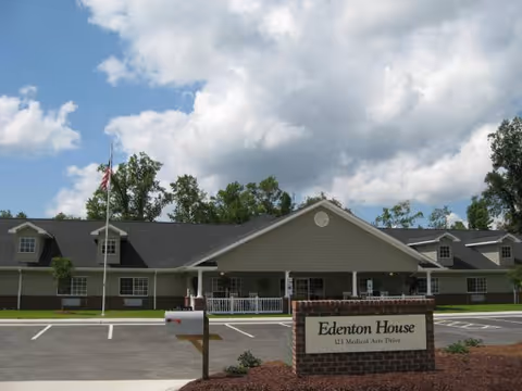 Edenton House senior living facility front view with parking lot and sign