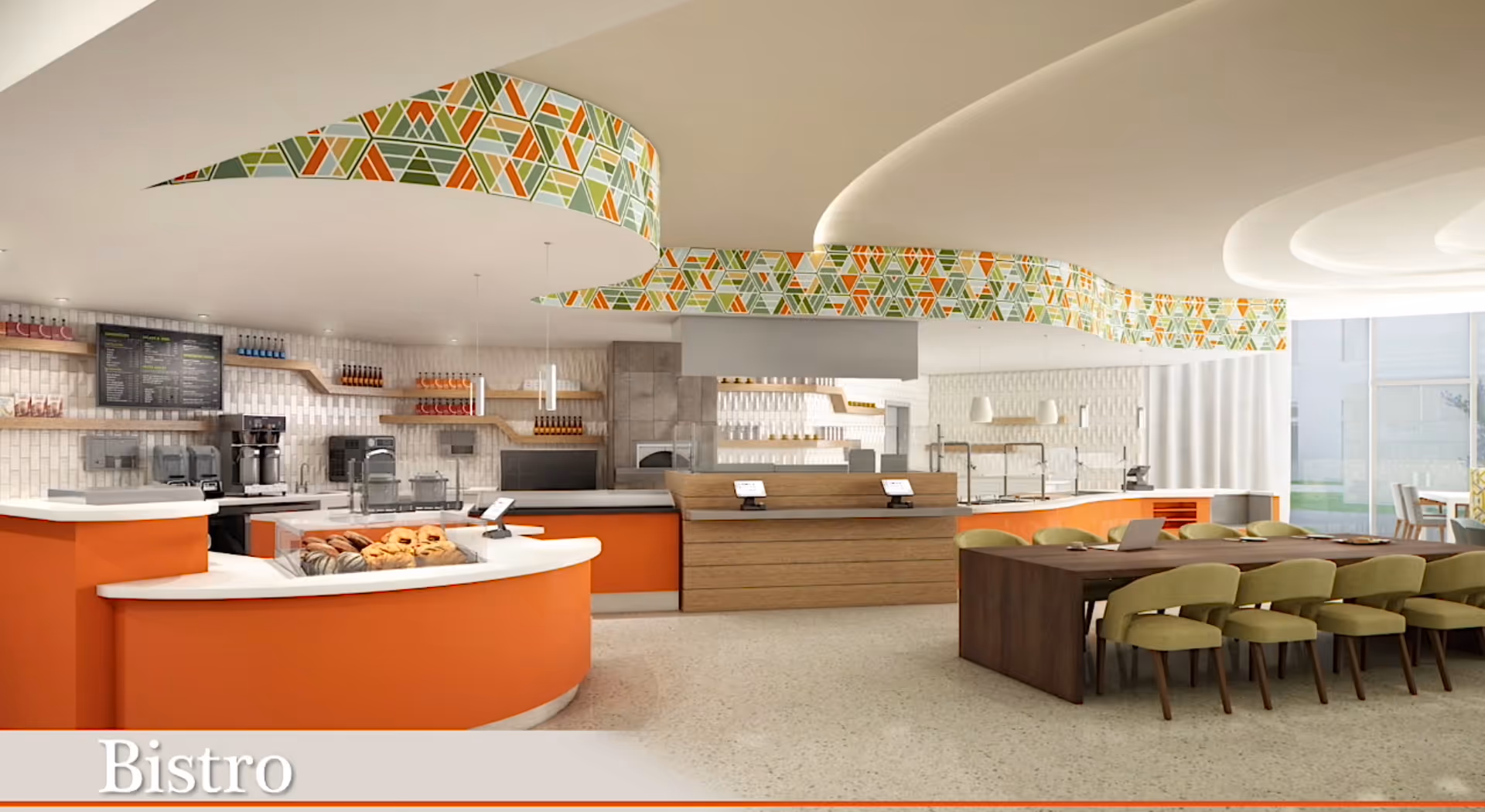 A modern bistro area with an orange curved counter displaying pastries, coffee machines, and shelves with bottles. There is a long wooden dining table with green cushioned chairs. The ceiling has a decorative geometric pattern in green, orange, and white. Large windows allow natural light to fill the space.