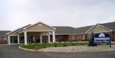Exterior view of Legacy at Forest Glen showing a brick building with a covered entrance.