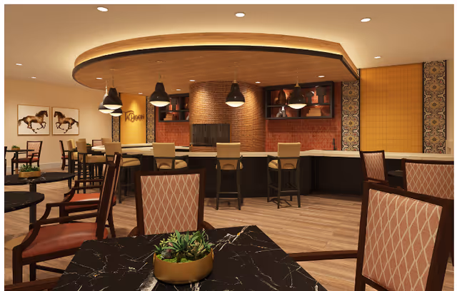 Warm, upscale dining/lounge area with a curved bar, pendant lights, and tables with upholstered chairs.