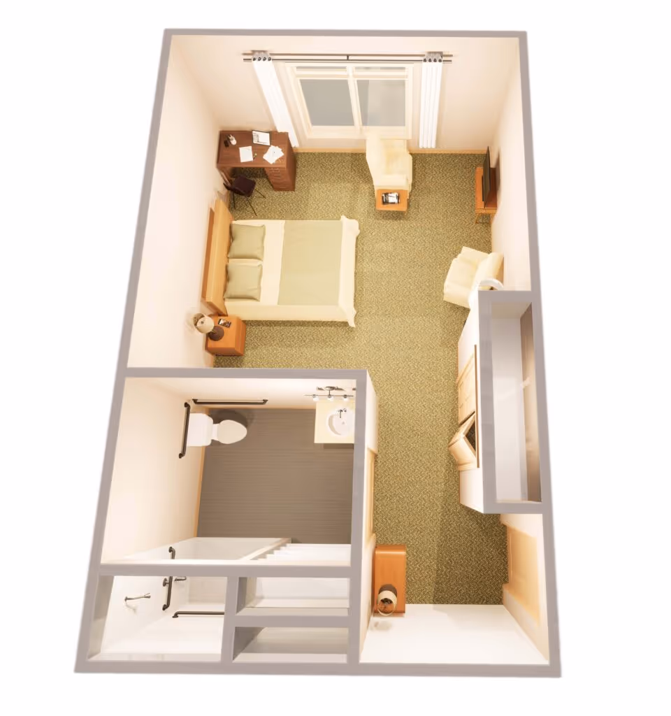 3D floor plan of a memory care facility room showing a bedroom with a bed, two armchairs, a desk with a chair, a TV, and a bathroom with a toilet, sink, and shower.