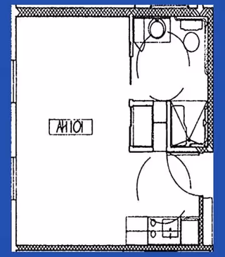 Architectural floor plan of a studio apartment labeled A101, showing a combined living and sleeping area, a bathroom with a toilet and sink, and a small kitchen area with a sink and stove.