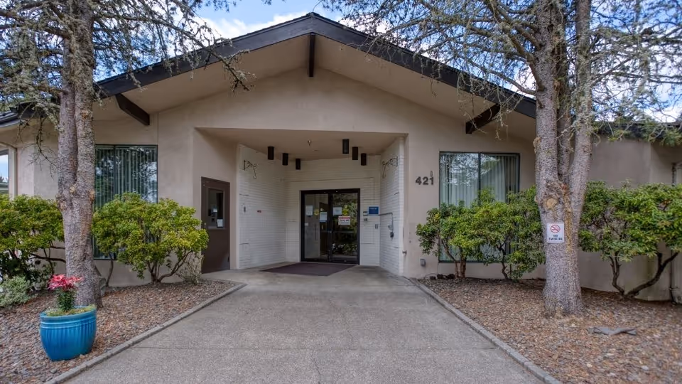 Front entrance of the Prestige Post Acute And Rehabilitation Center surrounded by greenery.