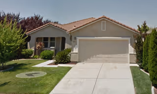 Front exterior of Angels Sunrise Villa: a single-story beige house with a two-car garage.