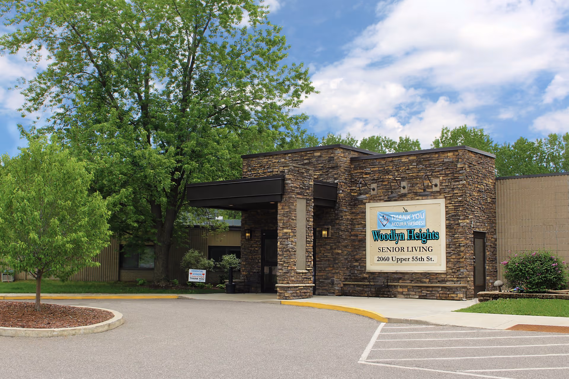 Front entrance of Woodlyn Heights Senior Living with a stone facade and visible signage.