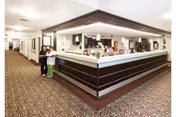 Interior lobby at Crystal Cove Care Center with a reception desk and two staff.