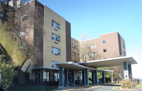 Front exterior of Providence Mount St. Vincent, a three-story facility, with a covered entrance canopy.