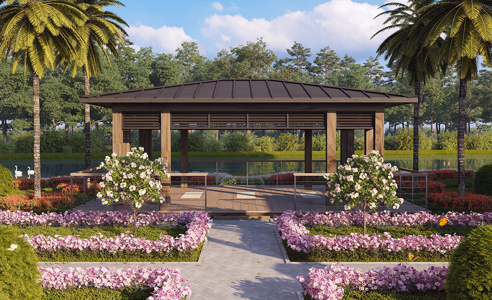 A wooden pavilion surrounded by manicured flower beds and palm trees beside a lake.