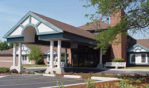 Front view of ProHealth Regency Senior Communities Brookfield entrance with a covered drop-off area.