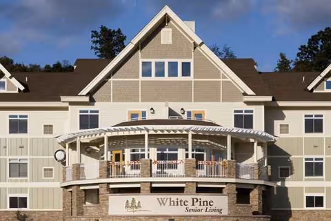 Cottage Grove White Pine senior living facility, front exterior with wraparound balcony.