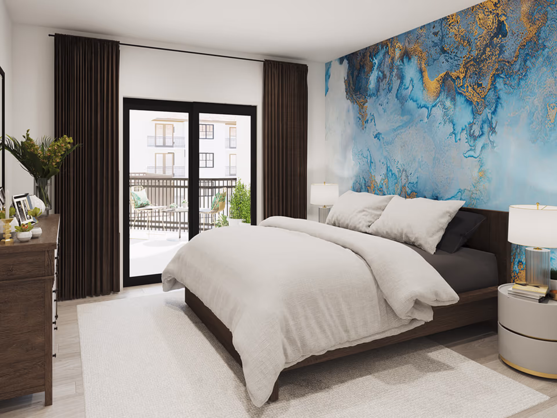 Well-lit bedroom with a bed, nightstands, a dresser, and sliding glass doors to a balcony, featuring a blue abstract accent wall.
