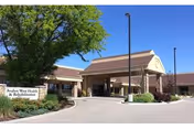 Exterior view of a senior living facility entrance with a covered drive-through.