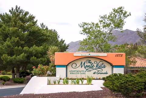 Exterior view of The Monte Vista at Coronado entrance sign with surrounding desert landscaping.