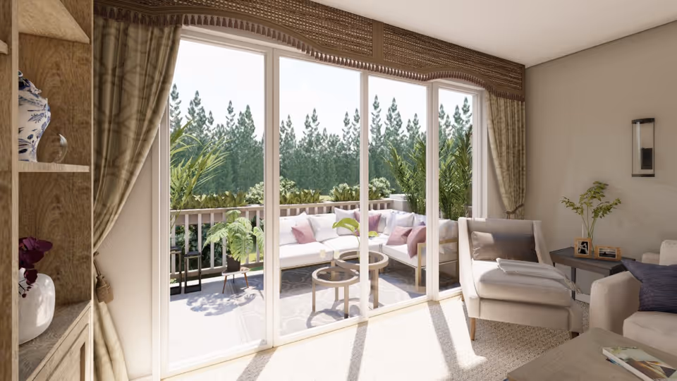 Sunny living room with armchairs and a sofa opening through sliding glass doors onto a balcony with outdoor seating and greenery.