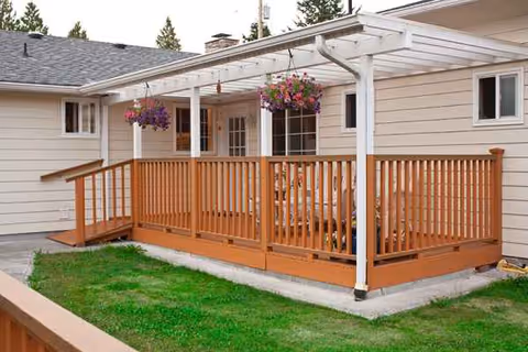 Exterior view of Lucia's Adult Family Home with a wooden deck and hanging baskets